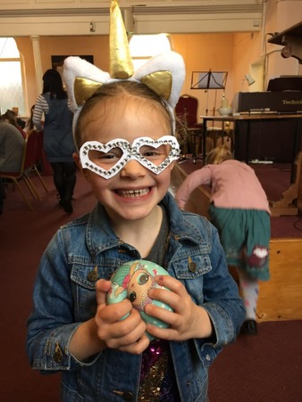 A girl wearing paper glasses